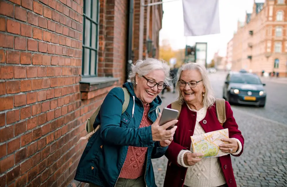 $300 charges & lost phones abroad: The costly mistake turning Euro trips into bill shock for Aussies 3 Two mature female travellers with map and mobile phone on city street – phone theft.