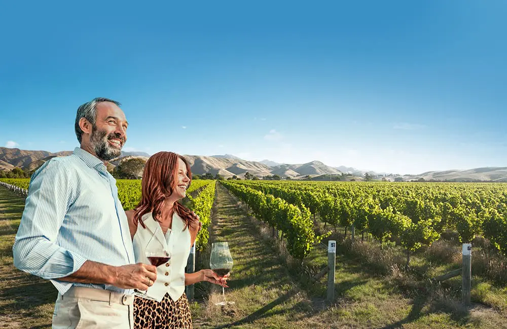 Luxury, leisure & late nights: Norwegian Spirit returns to Australia for adult-focused adventures in December 2025 2 Couple with wine glasses in vineyard in New Zealand. Image: NCL