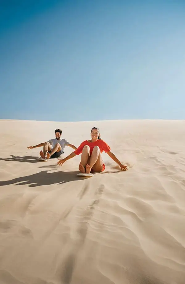From Tassie to the Hunter: Jetstar connects Hobart and Newcastle for the first time ever 3 Couple on Stockton Sand Dunes. Image: Destination NSW