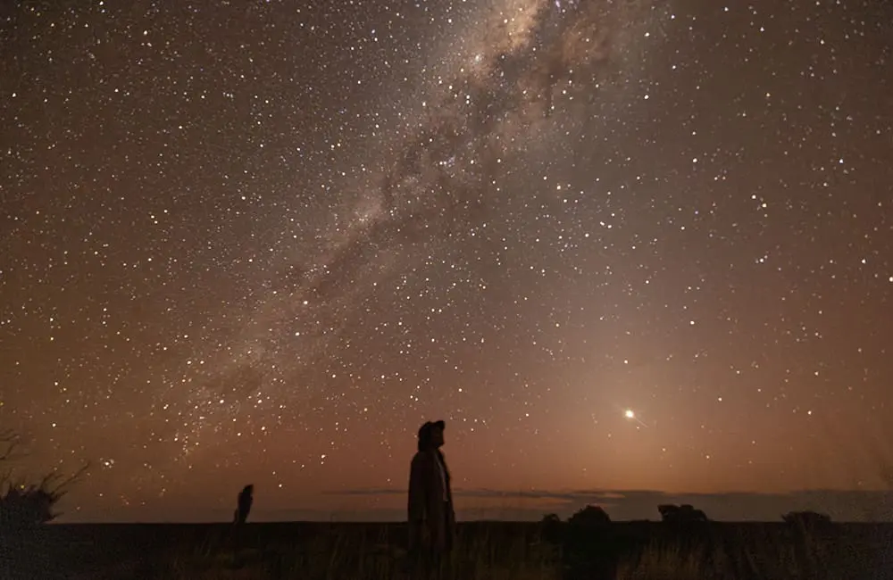 Steps ahead: Great Walks of Australia now has 15 multi-day treks with 2 new additions 1 Great Walks of Australia – Uluru-Kata Tjuta Signature Walk with starry night. Image: TWC