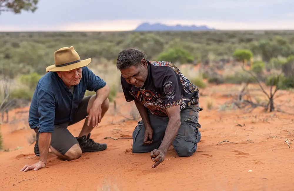 Steps ahead: Great Walks of Australia now has 15 multi-day treks with 2 new additions 2 Great Walks of Australia – Guide Heath Garratt with Aṉangu Traditional Owner on the Uluṟu-Kata Tjuṯa Signature Walk. Image: TWC