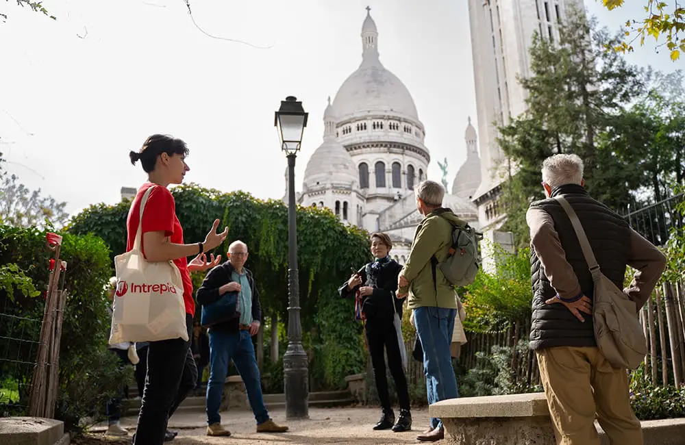 Intrepid’s new Short Breaks turn 27 days off into 59 days of adventure in 2026 3 Intrepid Travel trip leader with Short Breaks tour group in Montmartre, Paris, France.