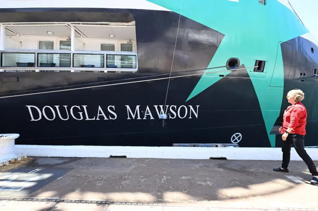 Emma McEwin breaks the ice across the Douglas Mawson.