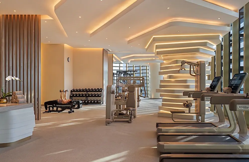The hotel’s fitness centre combines Technogym equipment with expansive city views.