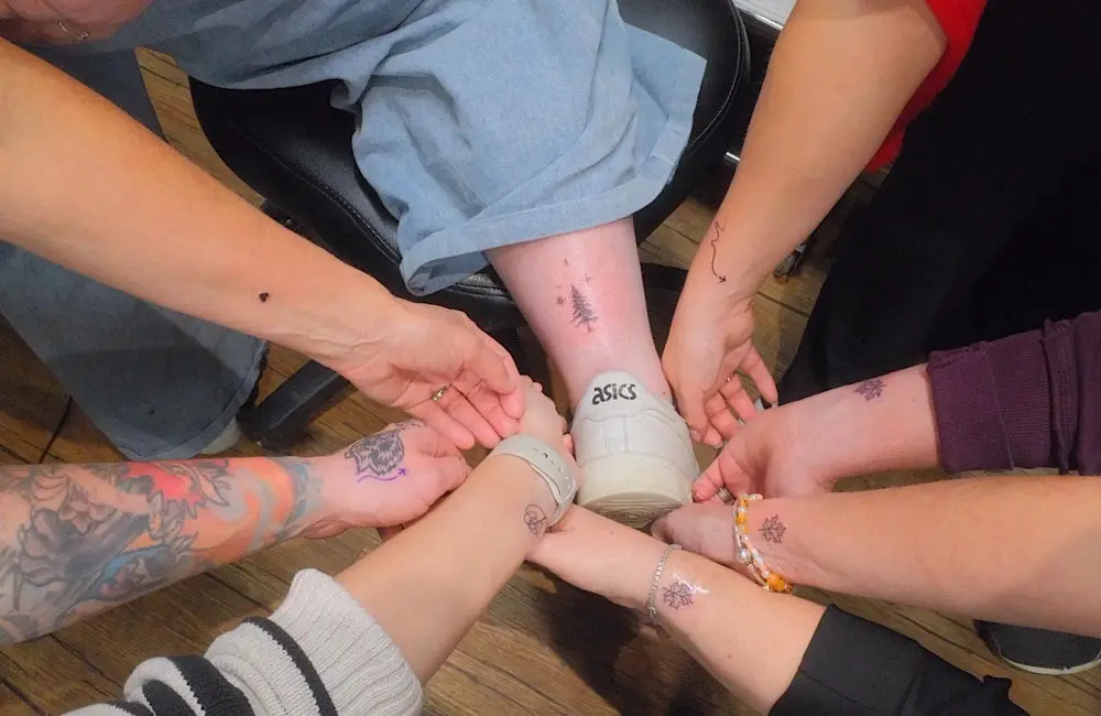 Six travel agents, one shared story: a country that moved them enough to wear it forever.