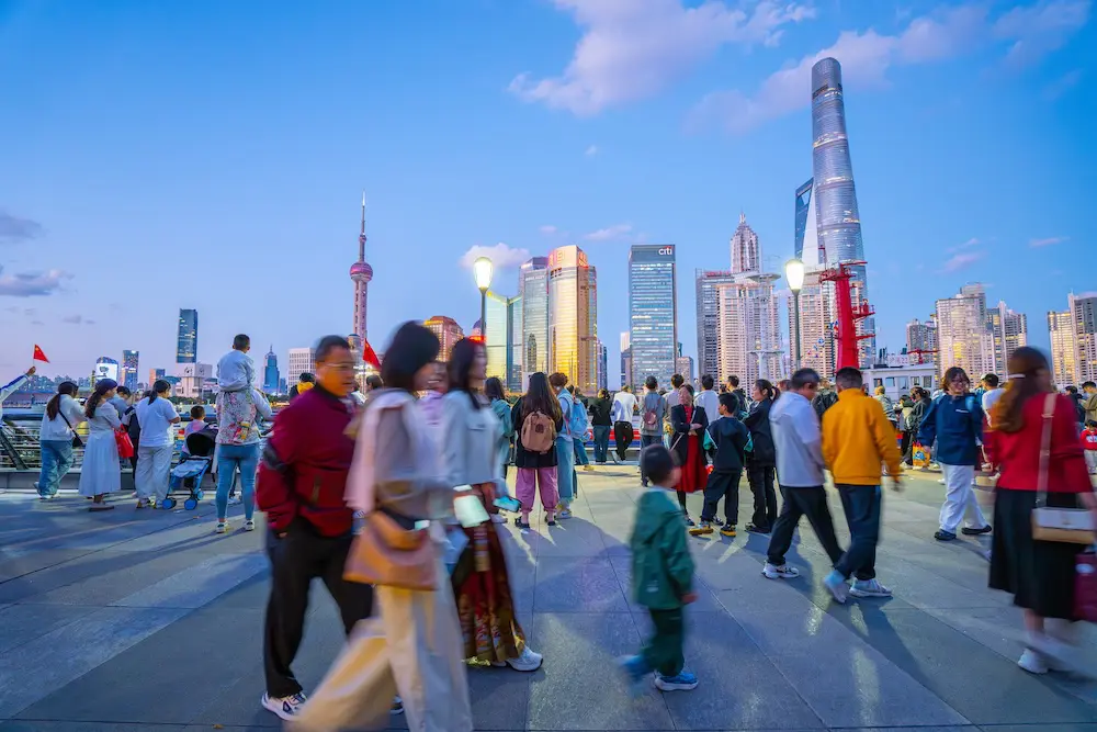 China travel gets boost with extension of visa-free entry for Aussies 1 Shanghai, China - October 3rd 2024: people take walking on The Bund in the evening, a scenic waterfront area in central Shanghai. It is one of the most famous tourist destinations in Shanghai.Lushengyi / Shutterstock.com