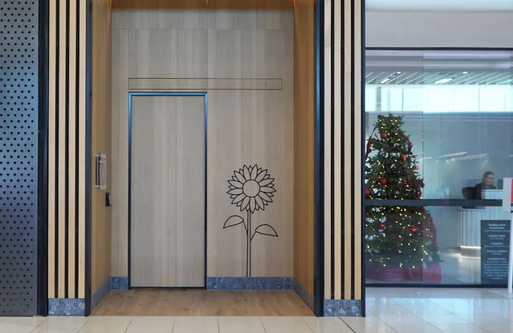 Exterior of Sensory Room at Adelaide Airport with sunflower motif on door.