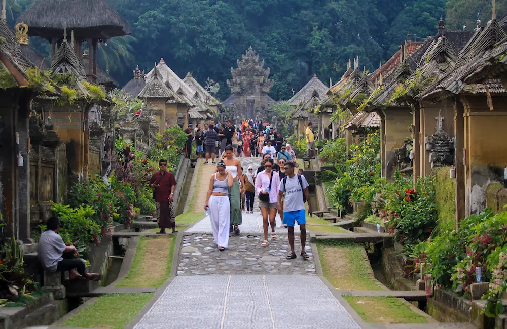 New Melbourne-Bali flights unveiled as travel to the Indonesian island continues to surge 1 Local and foreign tourists enjoy the atmosphere of the traditional Penglipuran Village street, surrounded by Balinese houses, lush gardens, and tropical scenery