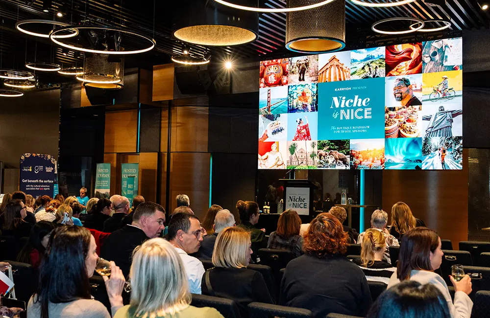 Close-up of Niche is Nice screen with audience in Brisbane 2025 - Karryon Top 10 Stories of the week