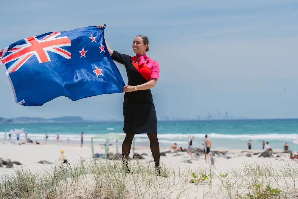 Qantas unveils new overseas routes, including the return of Gold Coast international flights 2 Qantas cabin crew at Kirra Beach with NZ flag