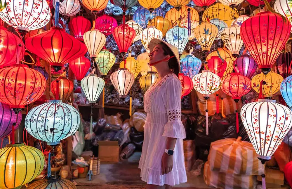 RACV reveals the risky last-minute insurance habit that cuts crucial coverage for festive travellers 2 Woman in lantern shop – last-minute travel insurance risk. Image: RACV