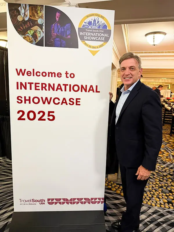 Travel South USA Chair Mark Ezell with Travel South USA International Showcase 2025 sign. Image: Cassie Tannenberg