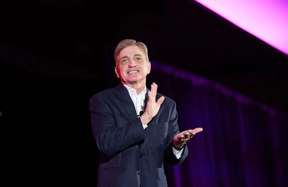 Travel South USA Chair Mark Ezell claps on stage.