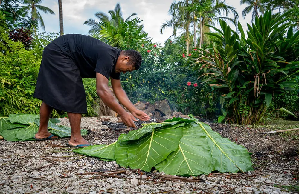Hit refresh: Tourism Fiji launches 'Holiday Happiness Reset' campaign for stressed-out Aussies 3 Man tends to a Fiji lovo. Image: Brook Sabin