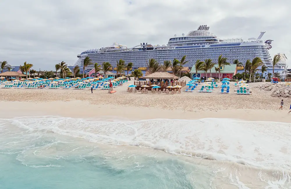 Wide image of Chill Beach at Royal Beach Club Paradise Island with Royal Caribbean cruise ship in background.