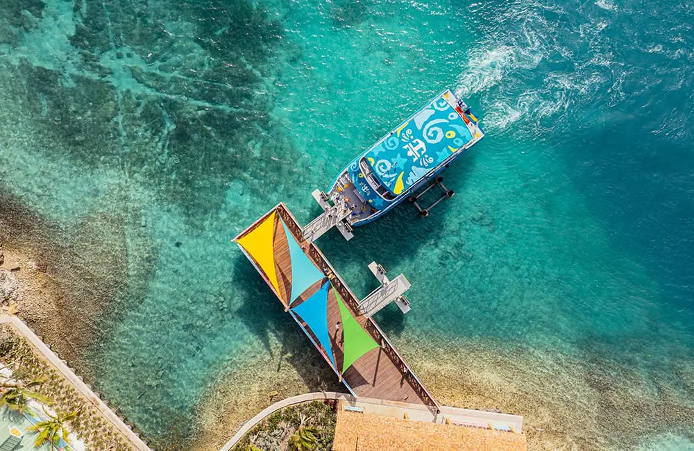 Aerial image of colourful ferry docked at Royal Beach Club Paradise Island.