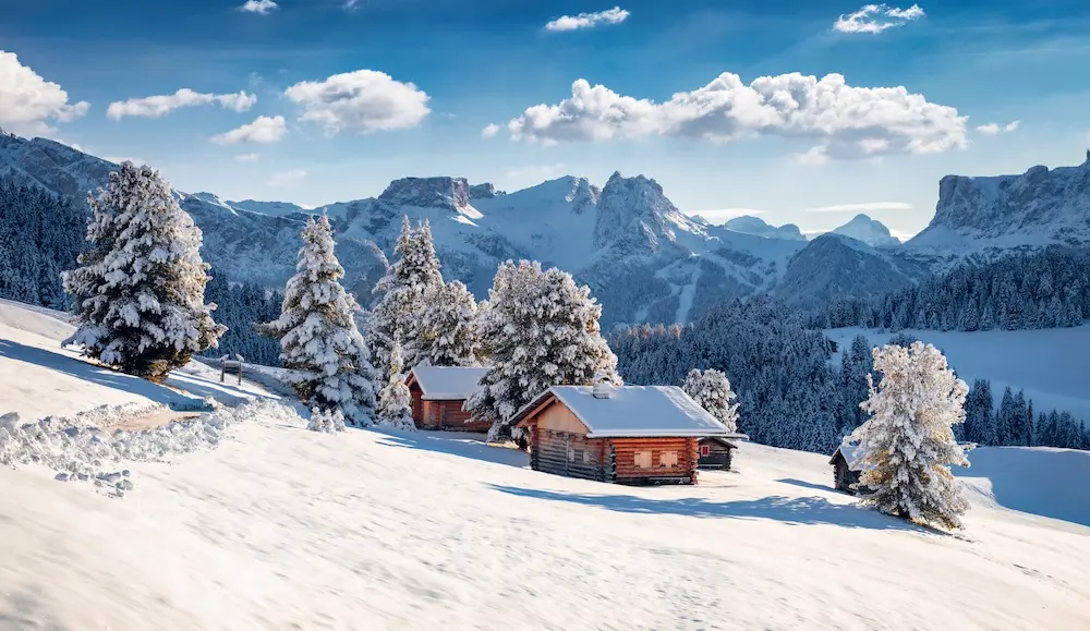 Frosty morning view of Alpe di Siusi village. Breathtaking winter landscape of Dolomite Alps. Majestic outdoor scene of ski resort, Ityaly, Europe. Beauty of nature concept background.