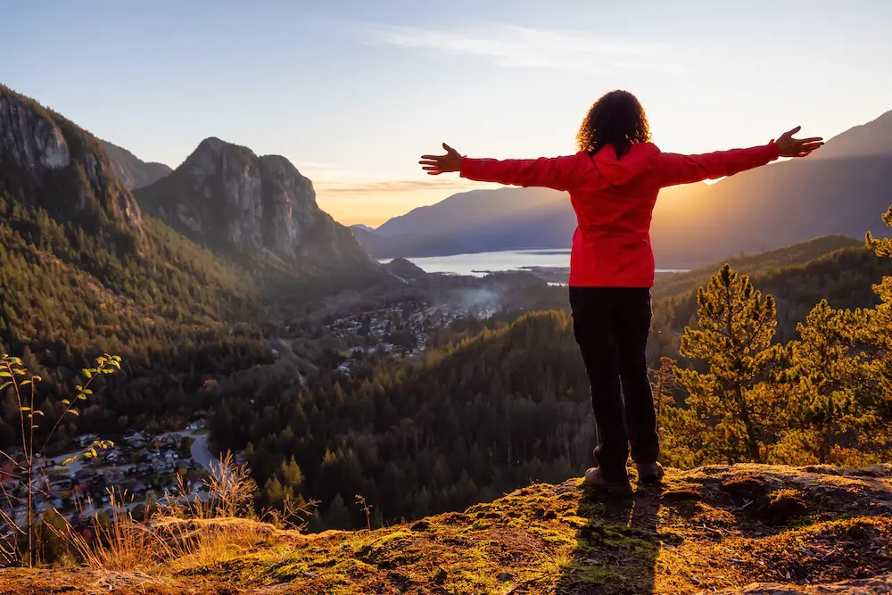 Adventurous Girl Hiking in the mountains during a sunny Autumn Sunset. Taken Squamish, North of Vancouver, British Columbia, Canada. Concept: Adventure, freedom, lifestyle