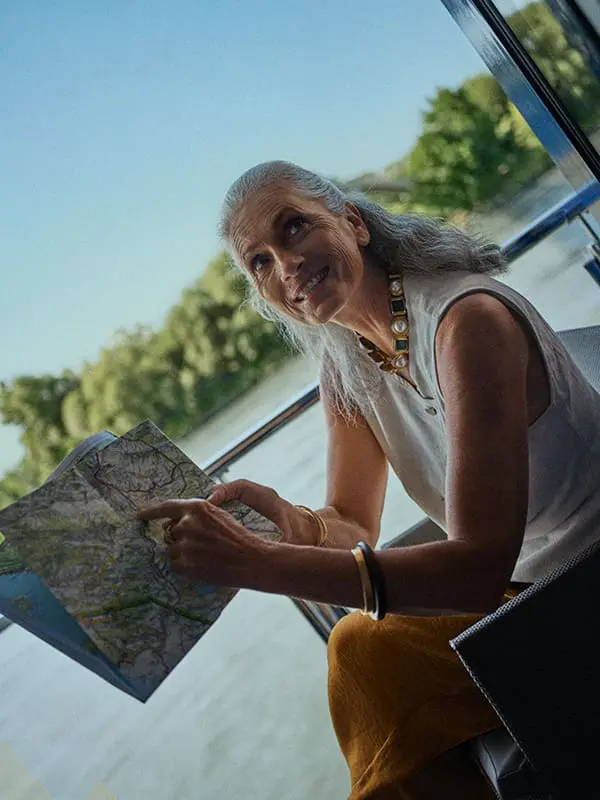 AmaWaterways guest with map on board river ship. AmaWaterways rebrand