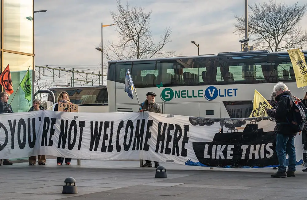 Extinction Rebellion climate activists protest against cruise ship pollution at Cruise Port Amsterdam in February 2025. Image: Milos Ruzicka/Shutterstock – Amsterdam cruise ban
