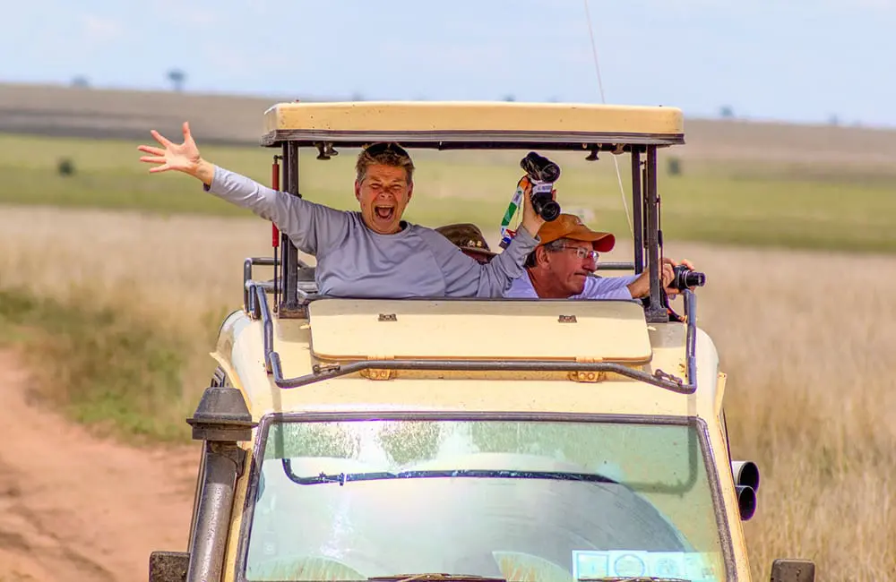 Older couple in safari vehicle in the Serengeti, Tanzania. Image: Chloe Marshall – Baby Boomer travel trends