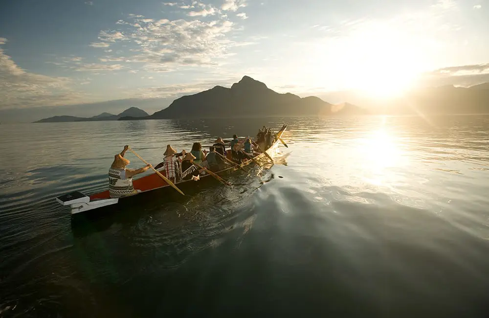 DBC-A group with Takaya Tours, rowing a traditional First Nations canoe in Howe Sound with mountains in the background-Patrice Halley