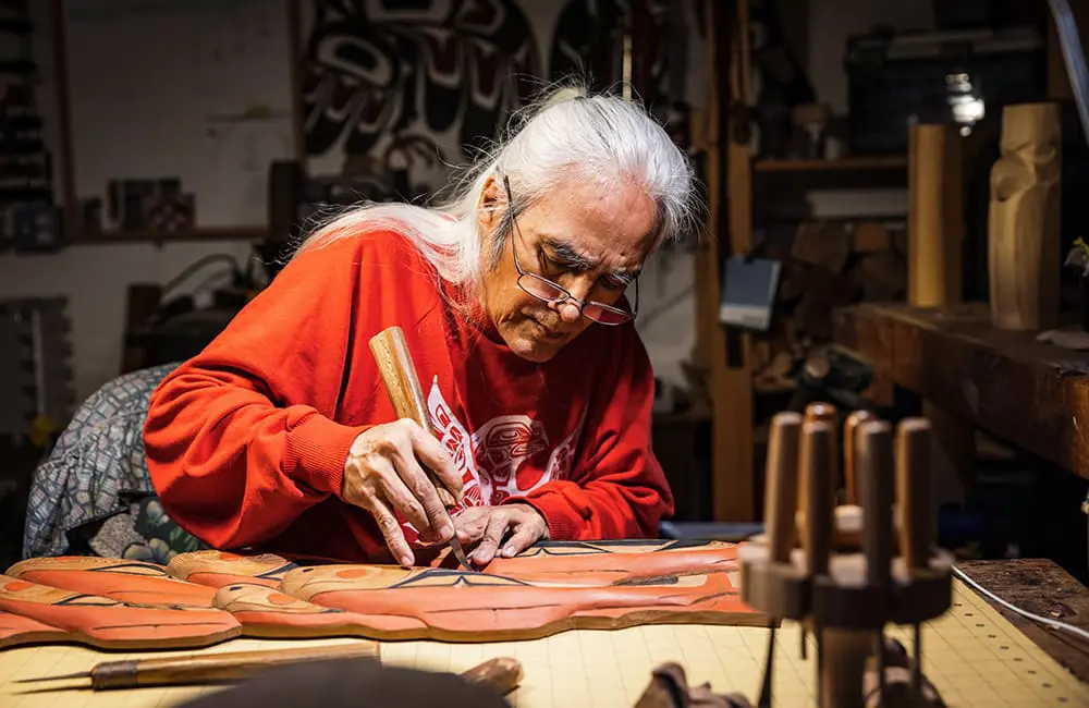 Nisga'a carver George McKay in his studio at the George Little House in Terrace. Image: Northern BC Tourism/Marty Clemens