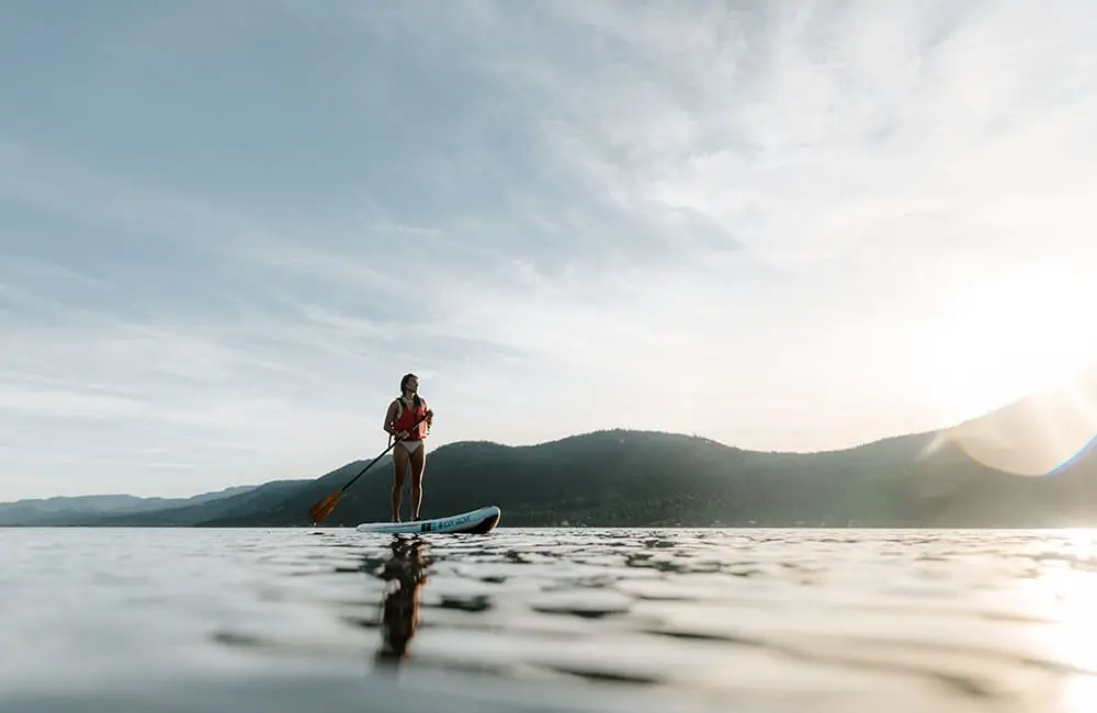 Woman standup paddleboarding on Little Shuswap Lake, Chase. Image: Destination BC/Mira Campbell