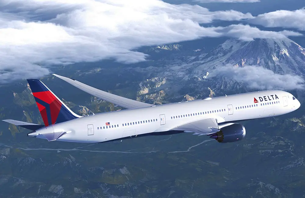 Delta ups Dreamliner order by 60 as it flies largest-ever international schedule in 2026 1 Delta Air Lines Boeing 787 Dreamliner aircraft flying over mountains.