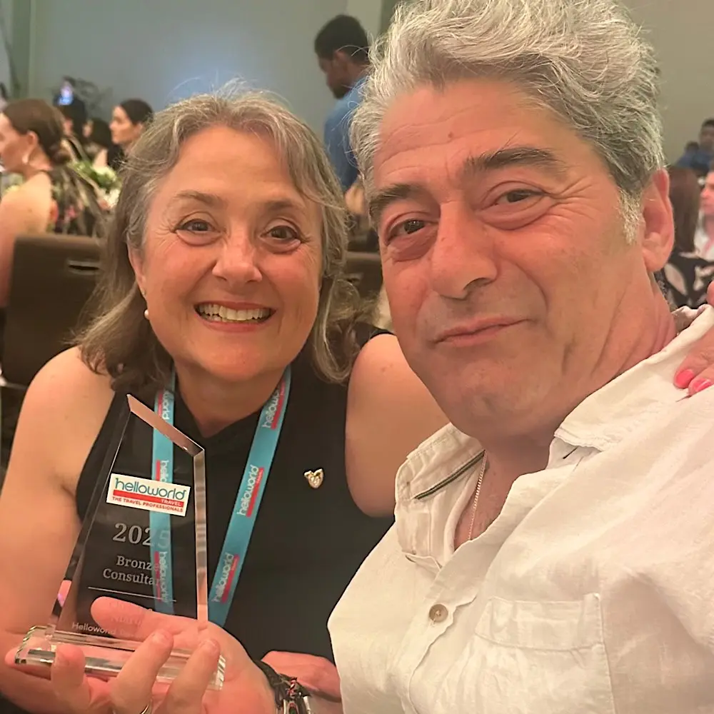 Helloworld Travel Oakleigh Owner/Manager Cecilia Barr celebrates Christos’s emotional moment at the Achievement Awards.