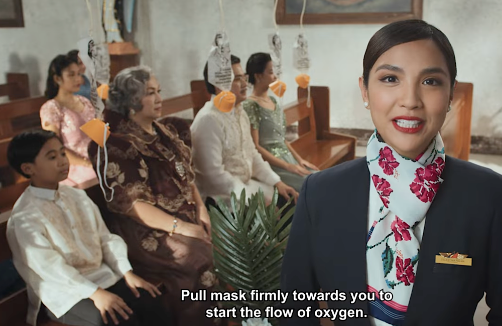Philippine Airlines drops oxygen masks into the middle of a wedding scene, folding safety instruction directly into the story’s most dramatic moment.