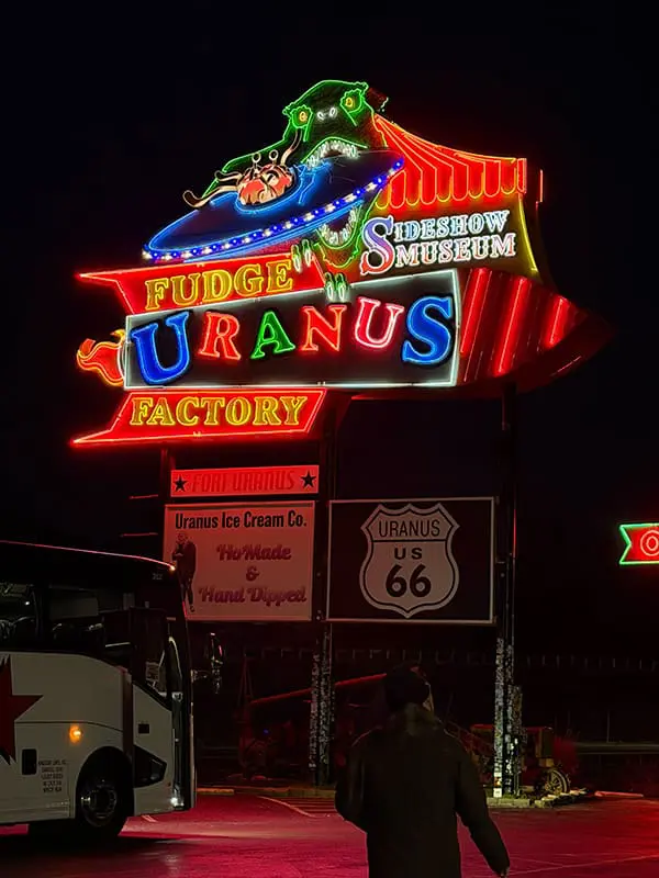 Uranus Fudge Factory neon sign on historic Route 66 at night. Image: Cassie Tannenberg