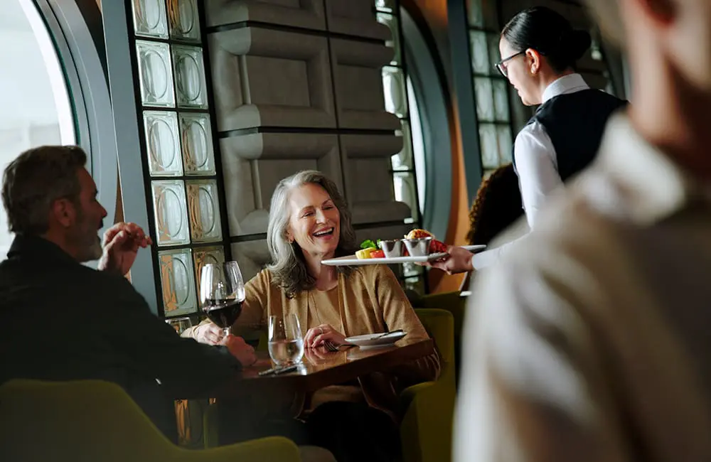 Couple dining at Cagney's on Norwegian Aqua.