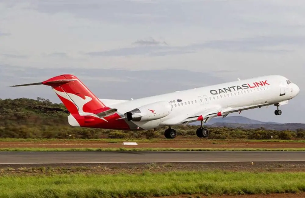 QantasLink F100 aircraft operated by Network Aviation taking off from Paraburdoo, WA.
