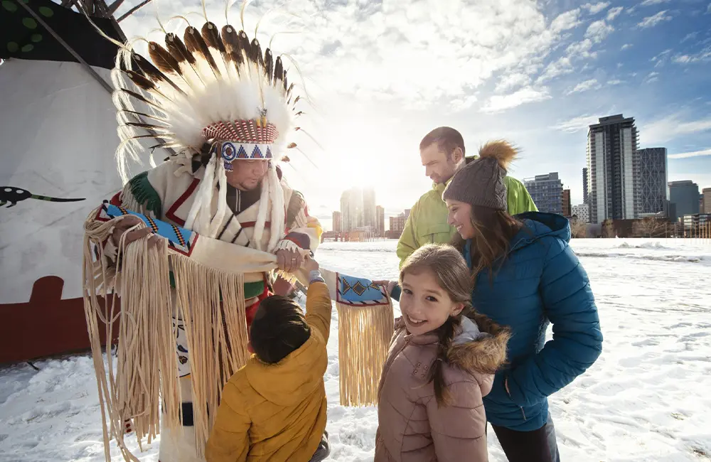 Podcast: Elevating Calgary: How Alisha Reynolds is redefining tourism for a thriving city 2 A family interacts with a Blackfoot elder as part of Chinook Blast, Calgary 2021