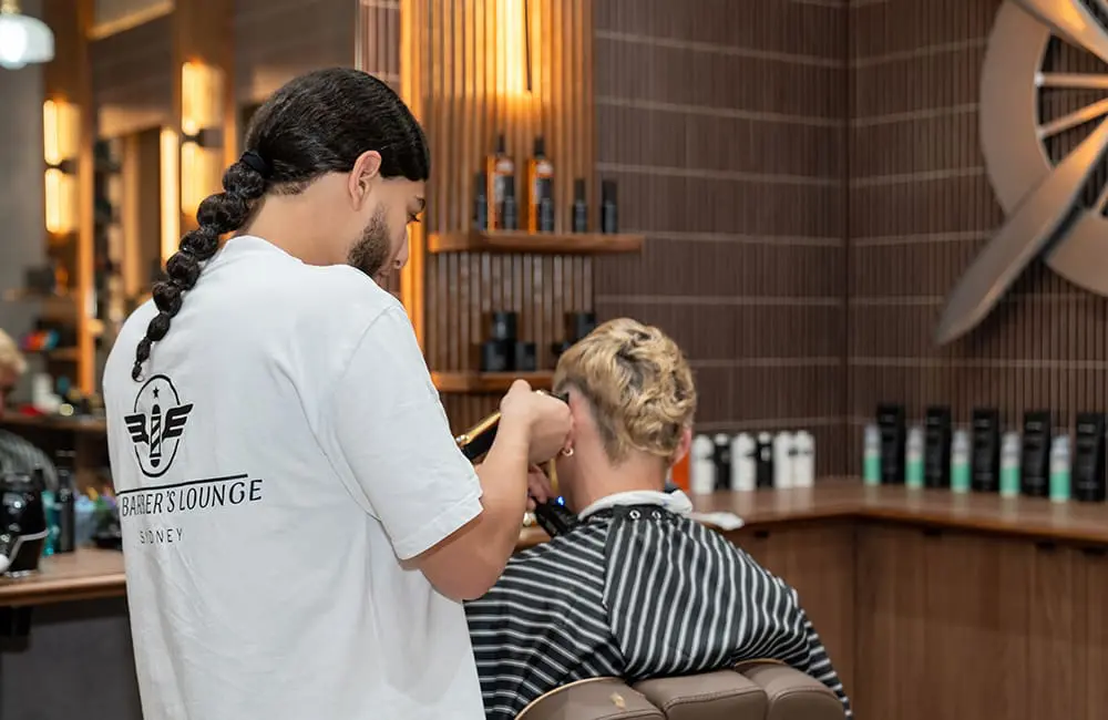 Customer being groomed at Barber's Lounge in Sydney Airport's T1 International Terminal.