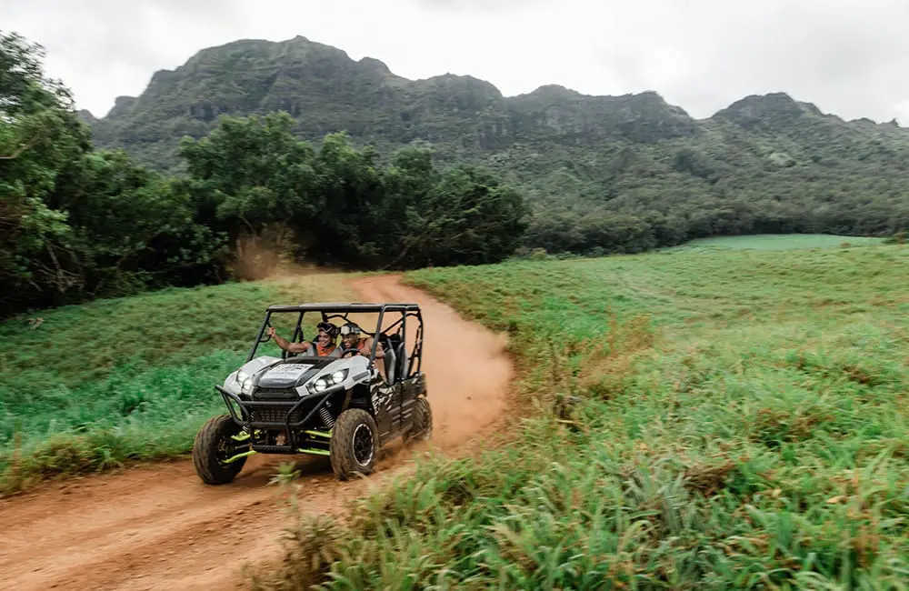 Couple in 4WD buggy on dirt road on Kauai, Hawaiian Islands. Image: HTA