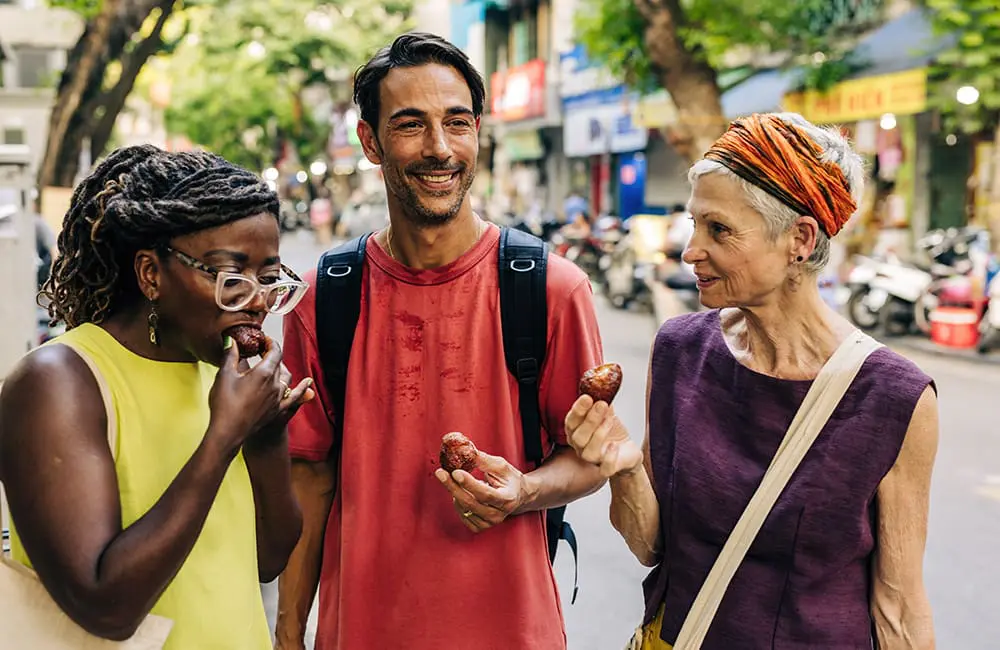 Intrepid Travel group leader on walking tour in Hanoi, Vietnam.