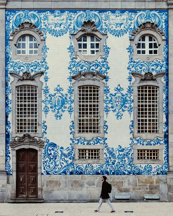 Man walking past tiled building in Portugal – Collette 2026 travel forecast