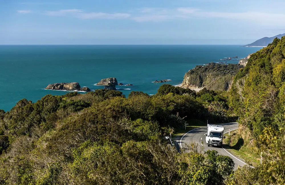 Motorhome on Haast highway on New Zealand's west coast – Tourism New Zealand Active Escapes campaign. Image: Miles Holden