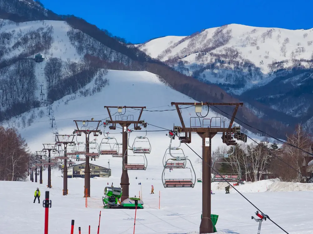 Second Australian dies on Japan's mountains in less than a week 2 Perspective view of multiple ski lifts on a wide piste (Tsugaike Kogen, Hakuba, Nagano, Japan)
