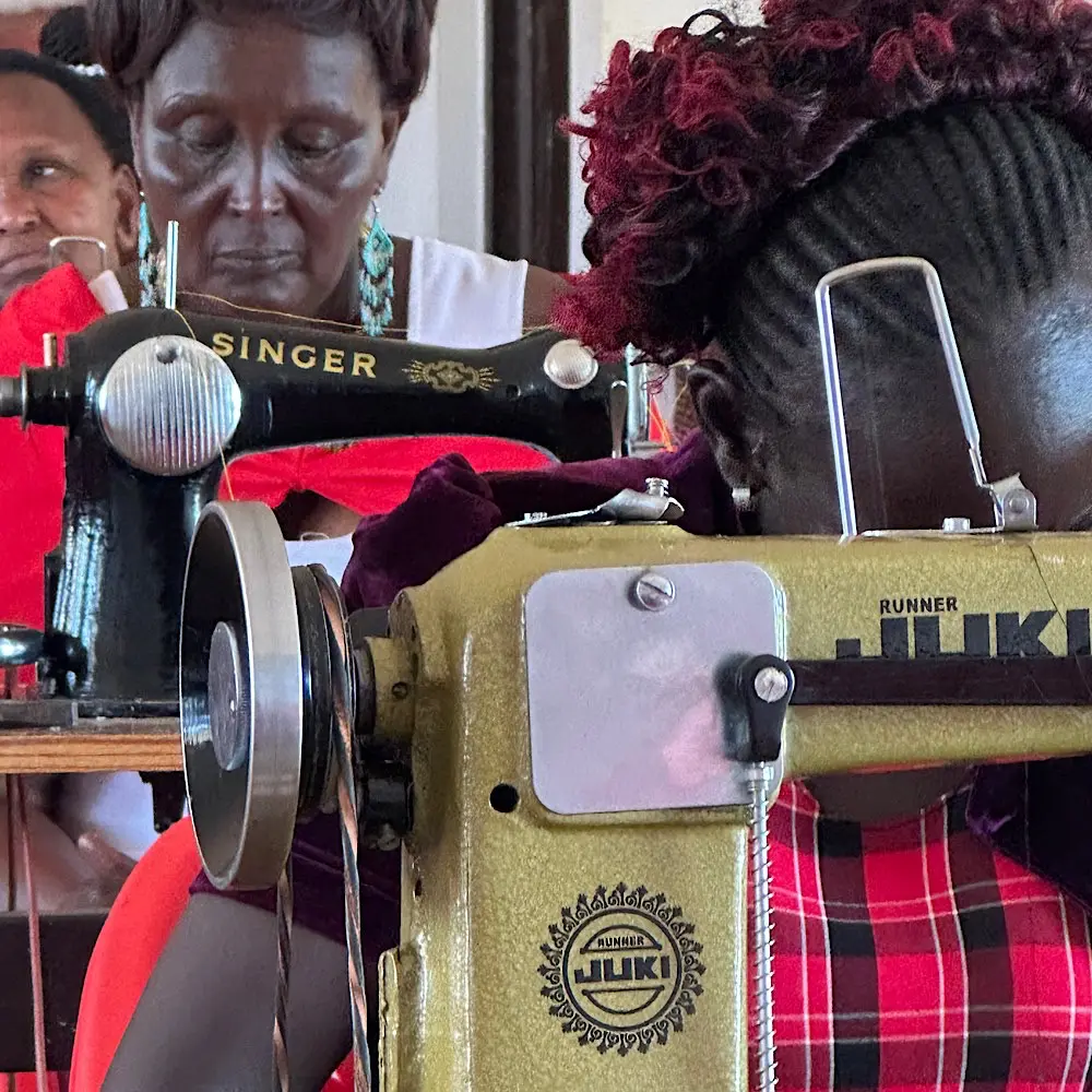 Tailoring classes at the Patinaai Osim hub currently use treadle sewing machines, with fundraising underway to install solar power and introduce electric equipment.