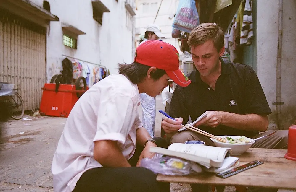 Blue Dragon founder Michael teaching a street kid in 2003