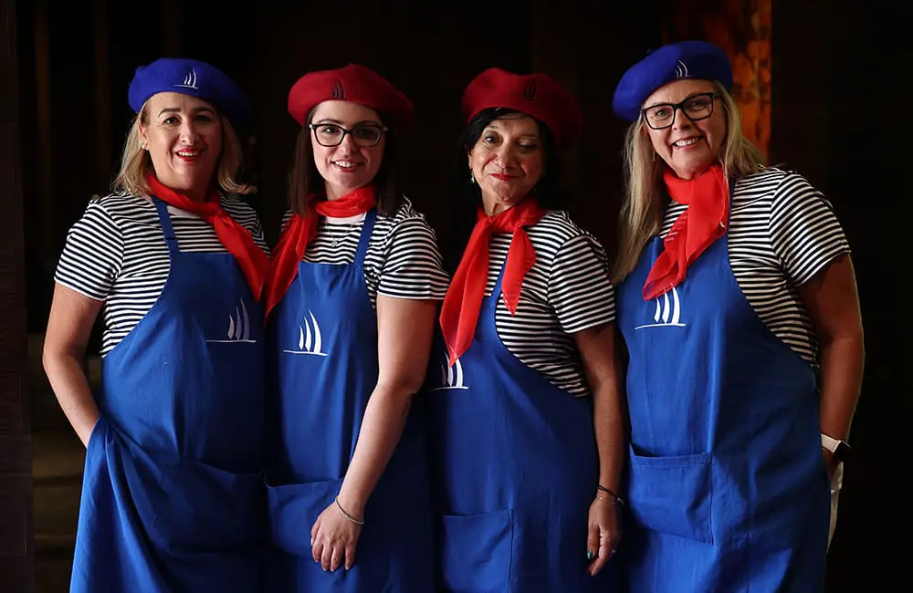 Ponant team in matching  French outfits