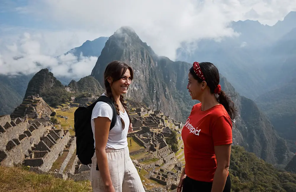 Intrepid Travel female trip leader with female traveller in Machu Picchu, Peru – Intrepid Women's Expedition