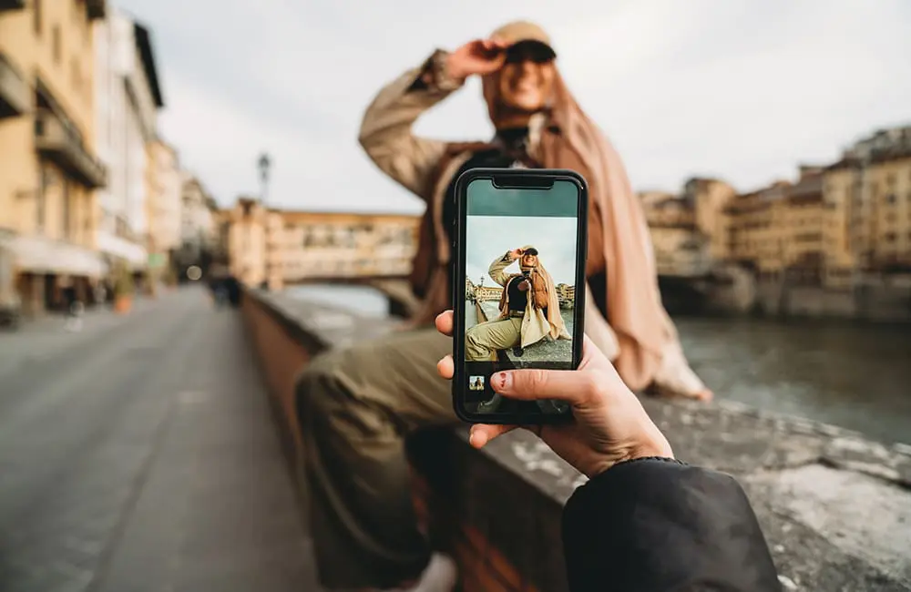 Insta feed to holiday fail: 57% of Aussies over influencer travel hype as agents offer the real deal 2 Social media influencer POV image of posing on bridge in Italy - influencer travel hype. Image: FilippoBacci/iStock