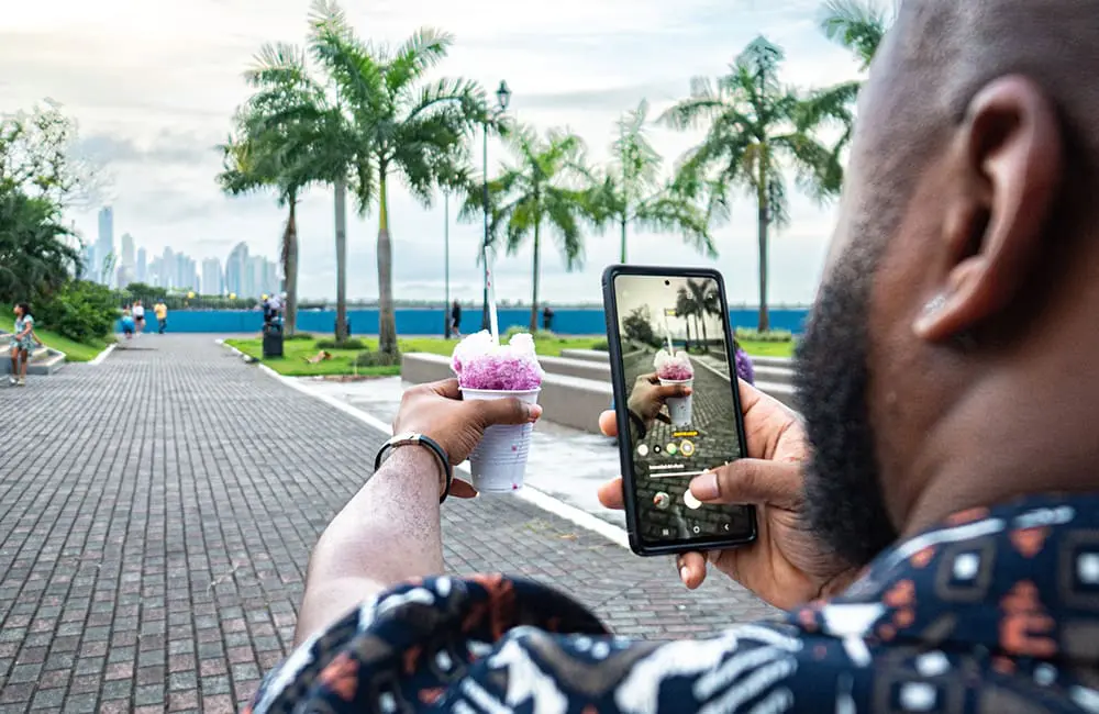 Insta feed to holiday fail: 57% of Aussies over influencer travel hype as agents offer the real deal 1 Male influencer in Panama City, Panama takes image of cone from POV shot. Image: Jeremy Poland/iStock