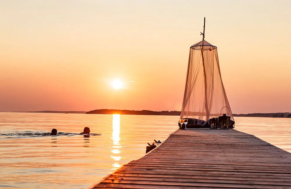 Midnight sun swimming at Lake Saimaa, Finland. Image: Mikko Nikkinen/Visit Finland – Chill Like a Finn campaign
