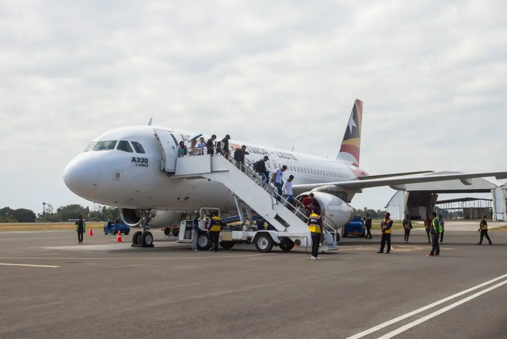 Passengers disembark a plane upon arrival at Presidente Nicolau Lobato International Airport in Dili, Timor Leste. The airport is the largest in Timor Leste.