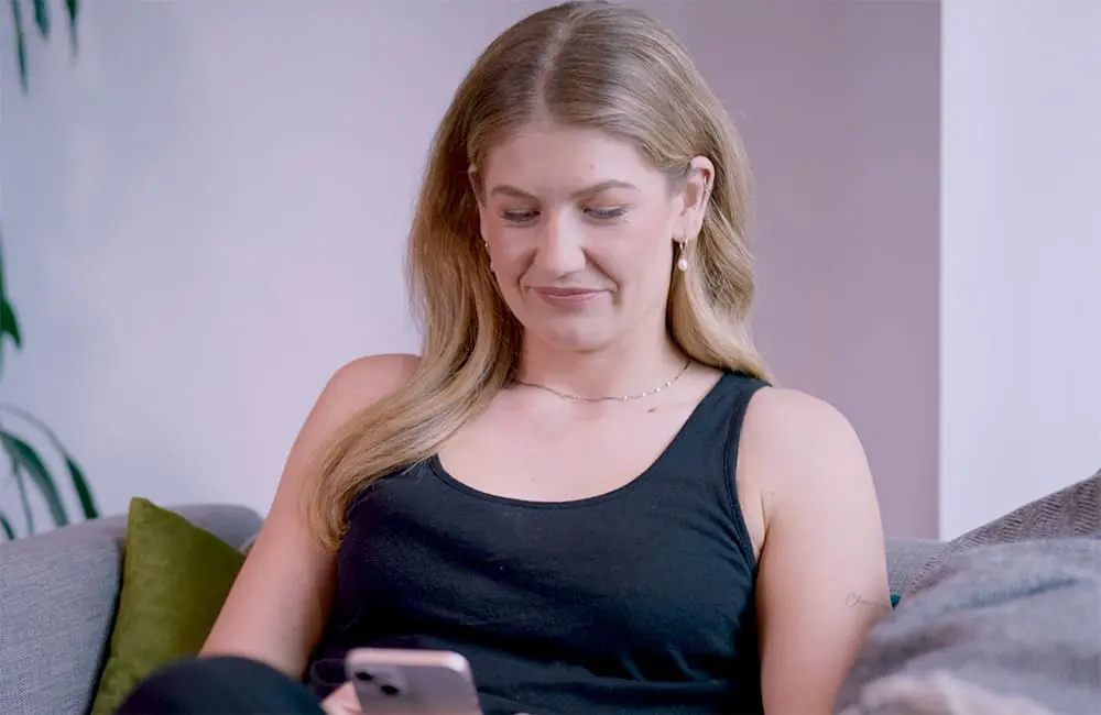 Air New Zealand pilots digital ID to cut queues and passport checks with Australian flights next 2 Woman at home with smartphone – Air NZ digital ID trial video still